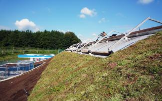 The vegetation mats are already installed in the steepest sections. Green roof with vegetation mats